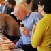 Rabbi Robert Levy, of Ann Arbor, bids on an item during a silent auction at Dining for Dollars fundraiser for HARC at Zingerman's Roadhouse on Wednesday.  Melanie Maxwell I AnnArbor.com